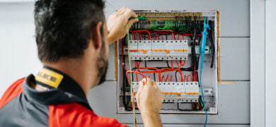 Registered Electrician carrying out detailed wiring and testing inside a residential electrical switchboard for safe, compliant installation.