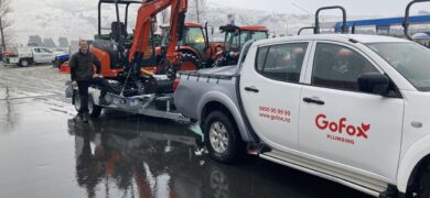 New Build Plumbing in Central Otago with a GoFox Plumbing Queenstown ute towing excavation machinery at a snowy Central Otago worksite