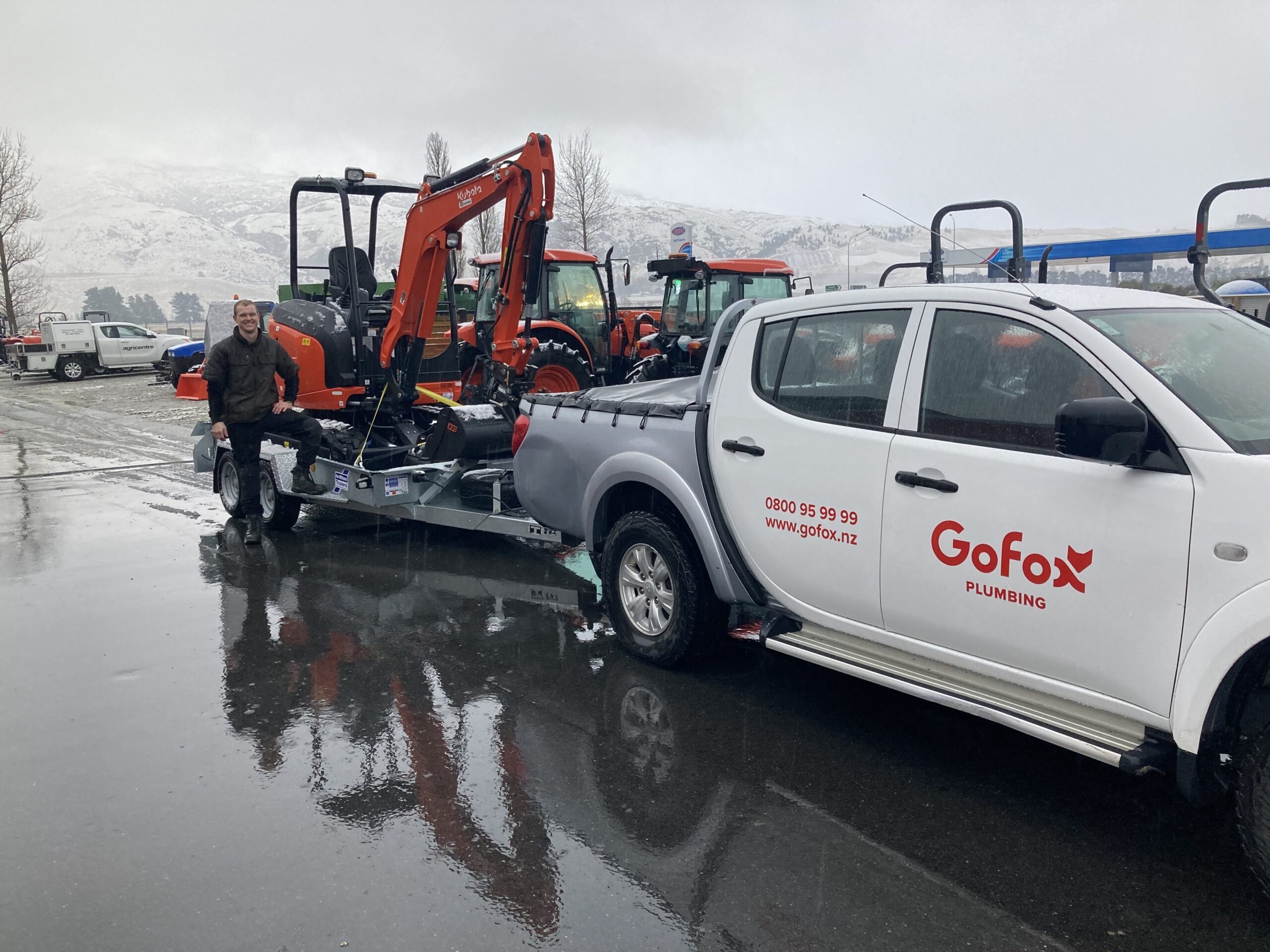 New Build Plumbing in Central Otago with a GoFox Plumbing Queenstown ute towing excavation machinery at a snowy Central Otago worksite