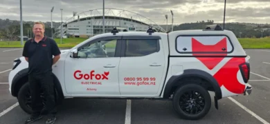 Local Electrician in Albany standing beside GoFox Electrical service vehicle outside North Harbour Stadium in North Auckland