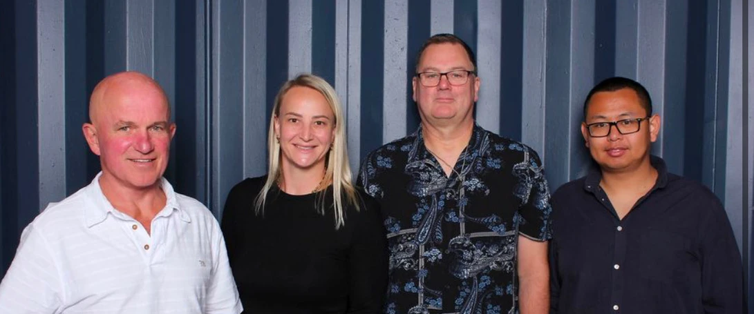 About GoFox head office team standing together in front of a grey backdrop, showcasing the leadership and support behind the GoFox franchise network.