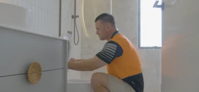 Bathroom Plumbing Upgrades with a GoFox plumber installing fittings beneath a modern vanity in a newly renovated bathroom