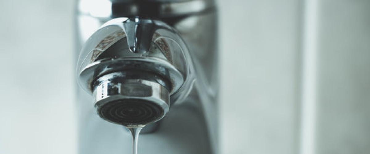 Leaking tap dripping water from a household faucet, illustrating a common plumbing issue that may require repair by GoFox Plumbing.