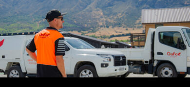 Is joining an electrical or plumbing franchise the right move – GoFox plumbing team member on site with branded vehicles in the background