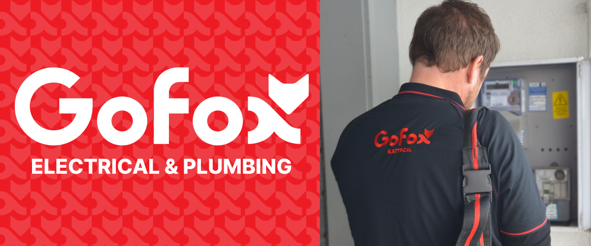 What changes when you join a franchise – GoFox electrical team member working on a switchboard with branded uniform and logo displayed