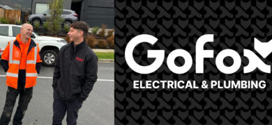 What a franchise provides – GoFox electrical and plumbing team members talking on site with branded vehicle in the background