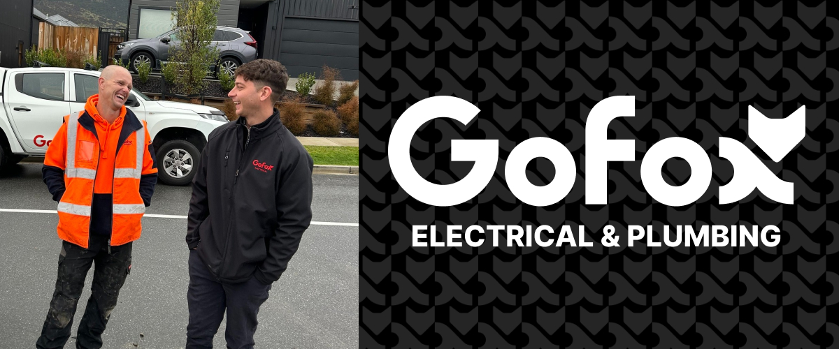 What a franchise provides – GoFox electrical and plumbing team members talking on site with branded vehicle in the background
