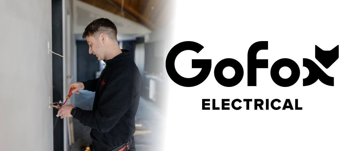 Licensed Electrician New Zealand: GoFox Electrical tradesperson working on wall wiring in a residential property