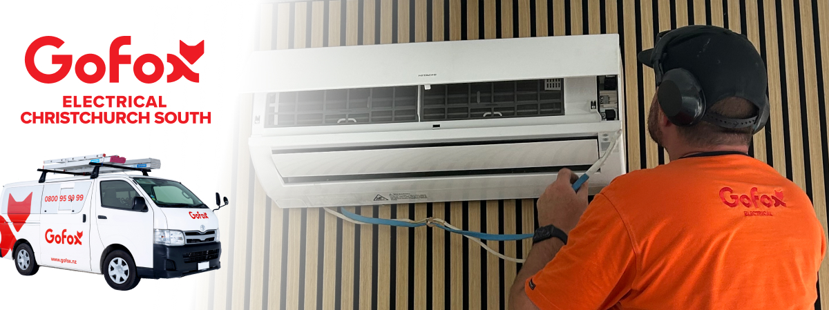 Best Electrician Christchurch South GoFox Electrical technician servicing a wall-mounted heat pump system in a Christchurch South property.