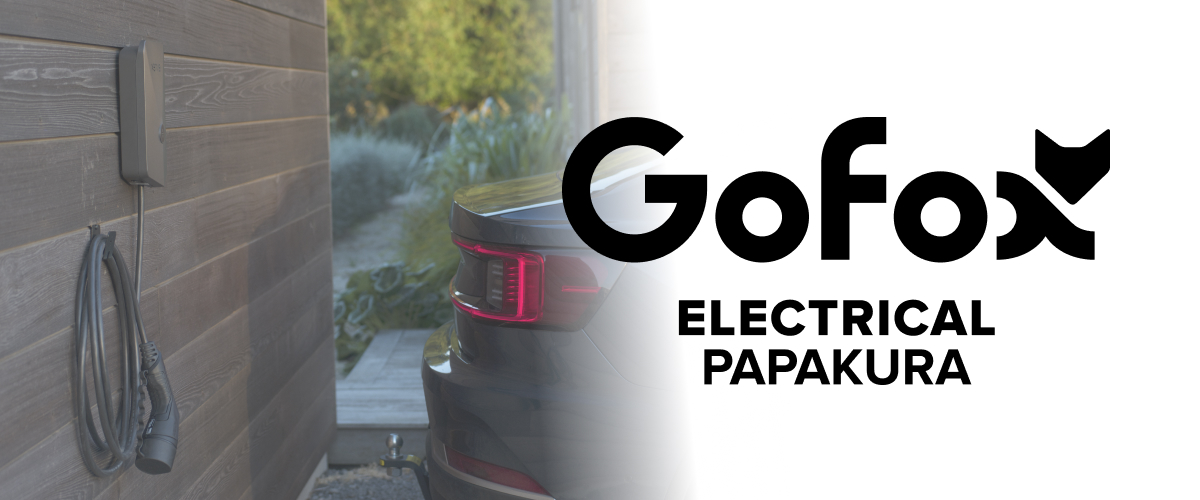 EV Charger Installation Papakura GoFox Electrical Papakura branded home EV charging unit installed beside an electric vehicle at a residential property.
