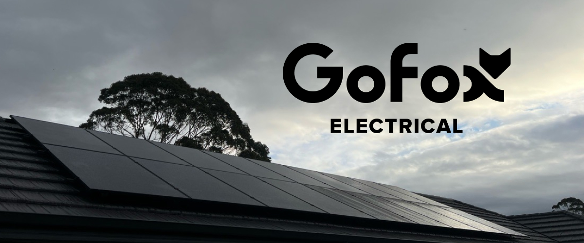 Solar roof suitability: black solar panels installed across a tiled New Zealand roof, framed by a tree and cloudy sky, with the GoFox Electrical logo.