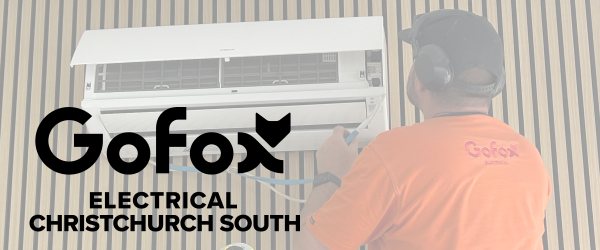 Heat Pump Installation Selwyn: GoFox Electrical technician fitting a wall-mounted heat pump unit indoors.
