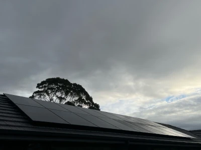 Roof top PV solar installation, cloudy sky background