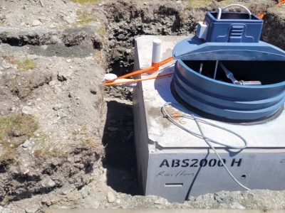 Waster water tank lowered into ground during installation